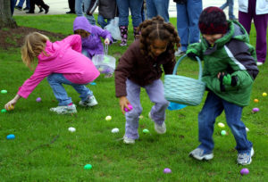 Kids picking up brightly colored plastic eggs
